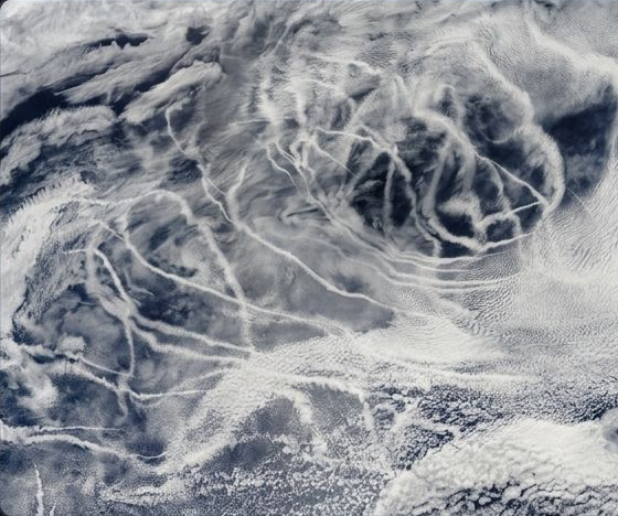 Satellite photo of ship tracks — bright cloud trails left by ship exhaust over the ocean